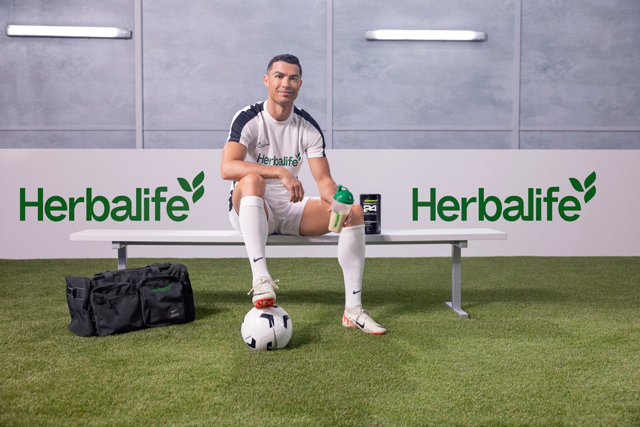Cristiano Ronaldo sitting on a bench with an Herbalife24 shake in hand.
