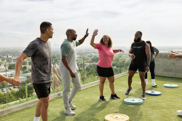 Friends high-fiving after completing a workout.