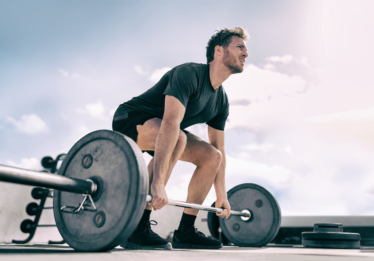 Gym fitness weightlifting deadlift man bodybuilding powerlifting at outdoor summer health club. Bodybuilder doing barbell weight lifting training workout with heavy bar. Gym fitness weightlifting deadlift man bodybuilding powerlifting at outdoor summer health club. Bodybuilder doing barbell weight lifting training workout with heavy bar.