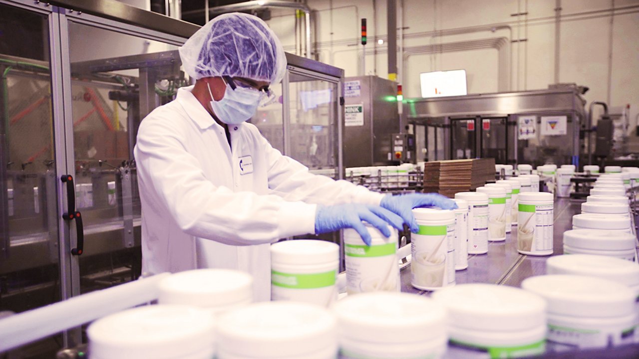 A facility worker inspecting Formula 1 products A facility worker inspecting Formula 1 products
